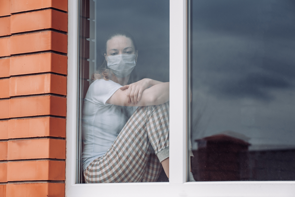 Woman at the window during lockdown (© Tatyana Blinova/Shutterstock) Woman at the window during lockdown (© Tatyana Blinova/Shutterstock)