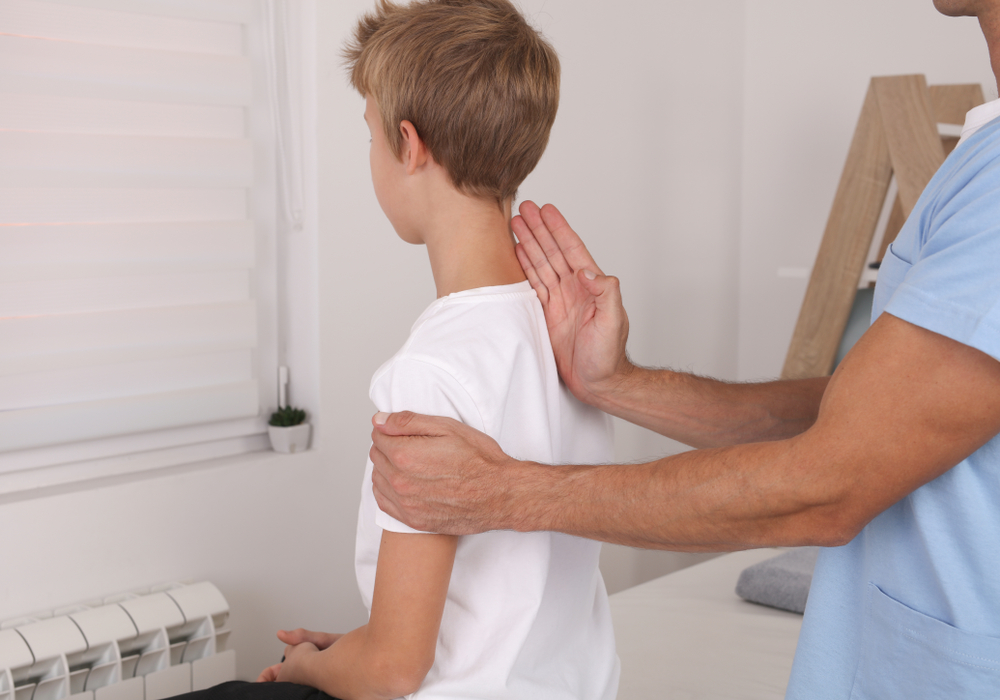 A child during a physiotherapy session - © Albina Gavrilovic/Shutterstock