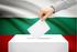 Elettore inserisce la scheda nell'urna sullo sfondo di una bandiera bulgara - © Niyazz/Shutterstock
