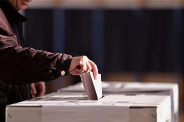 Voter places the ballot in the box - © roibu/Shutterstock