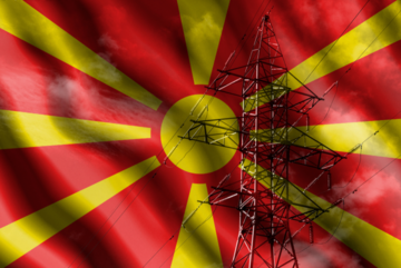 High-voltage transmission line on the background of the flag of North Macedonia - © Pilotsevas/Shutterstock