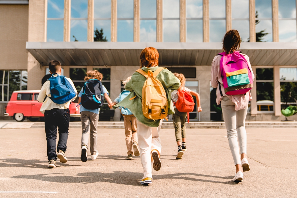Students entering school - © Inside Creative House/Shutterstock
