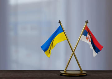 Serbian and Ukrainian flags - © Fly Of Swallow Studio/Shutterstock
