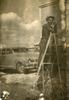 Paul Antaramian painting his American house in Yerevan with the Nash Ambassador car in the background to the left