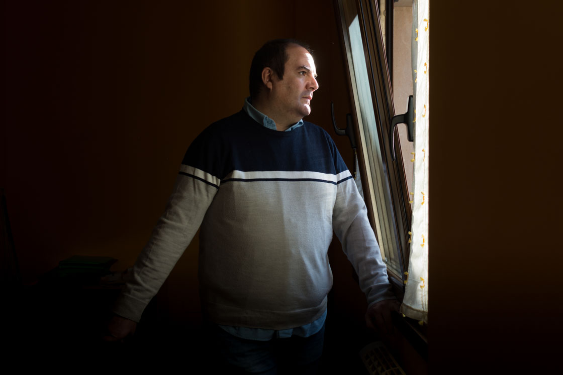 Andrés Colao, spokesperson for a Spanish charity related to mental health, stares through a window