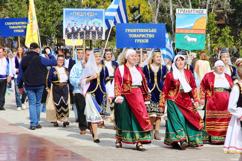 Defile participants of Greek community Ethnic Festival Mega Yorty in Greek National costume September 25, 2021 in Mariupol,Ukraine © Zurbagan/Shutterstock