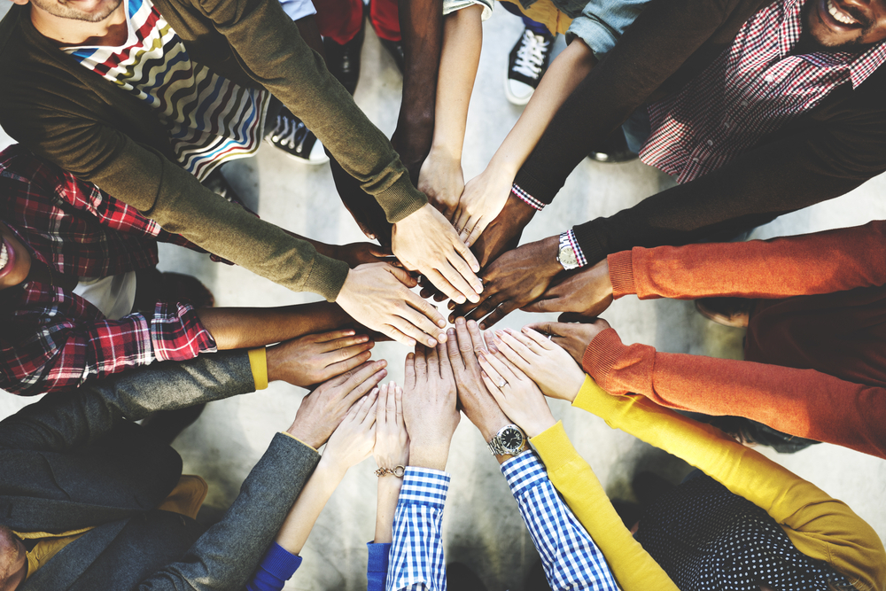 group joining hands together 