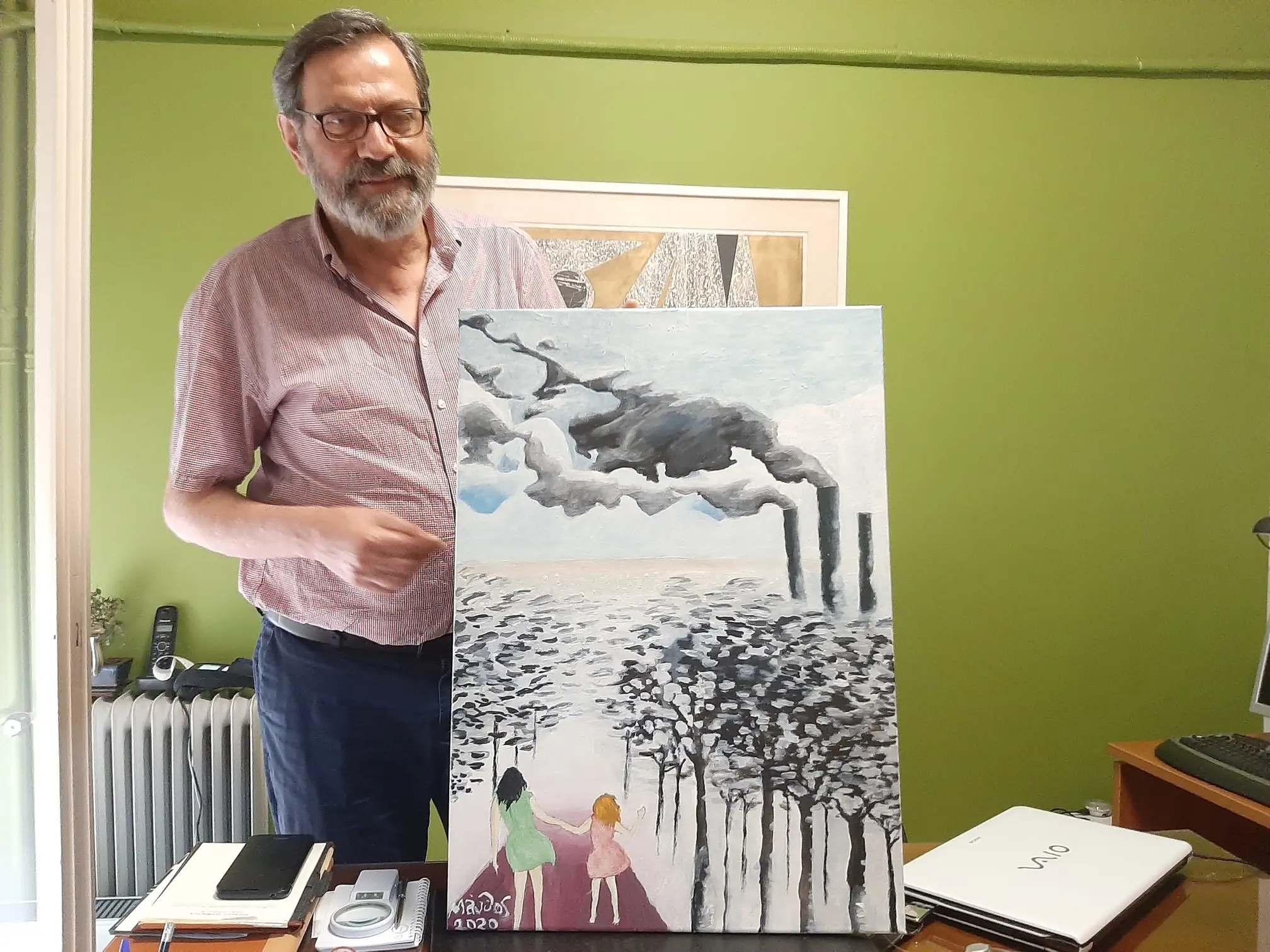 Cardiologist Matthaios Dramitinos, hobby painter, shows his latest work depicting pollution in his city