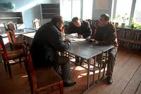 Georgi Vanyan (right) meeting with local officials at a school in Tekali, Georgia © Onnik Krikorian 2011